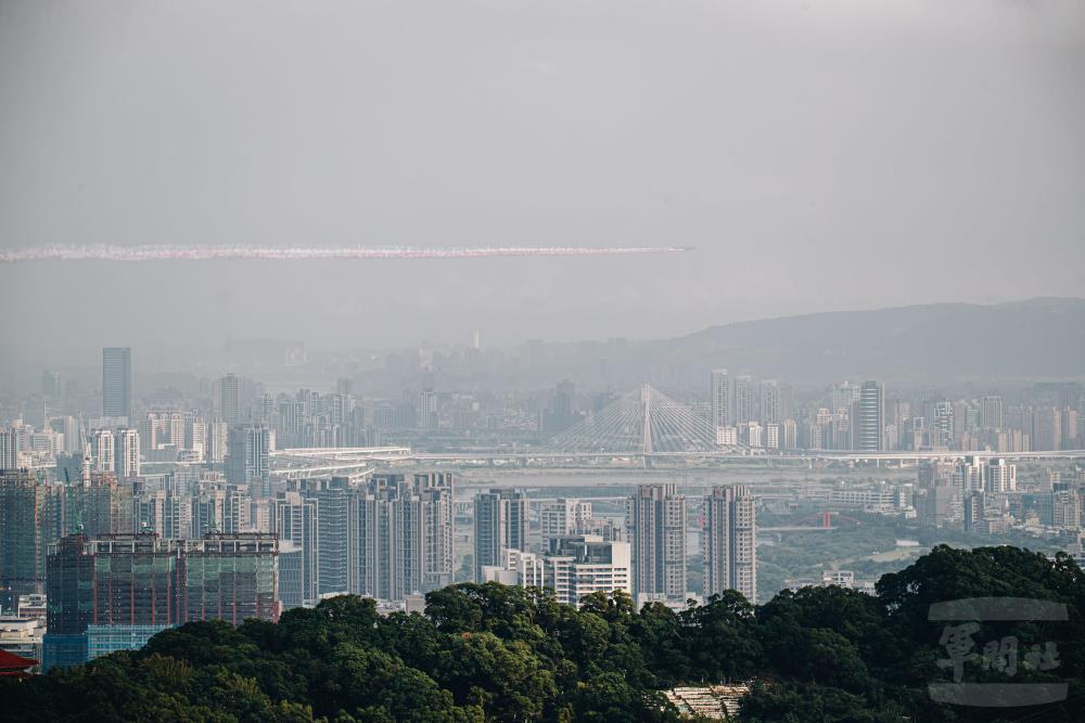 勇鷹高教機五機大雁隊形，施放彩煙通過臺北盆地。（軍聞社記者莊家豪攝）