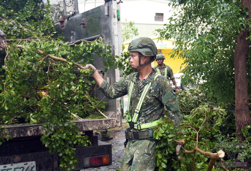 官兵協助搬運倒塌路樹。（軍聞社記者侯凱議攝）