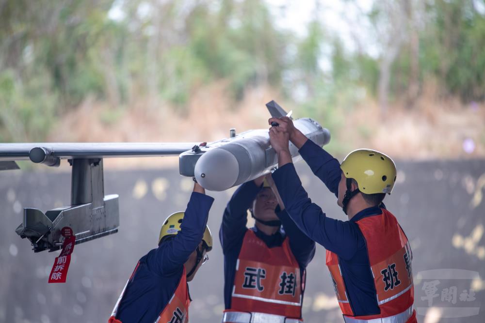 武掛人員在協力合作下完成彈藥裝掛。（軍聞社記者王進福攝）