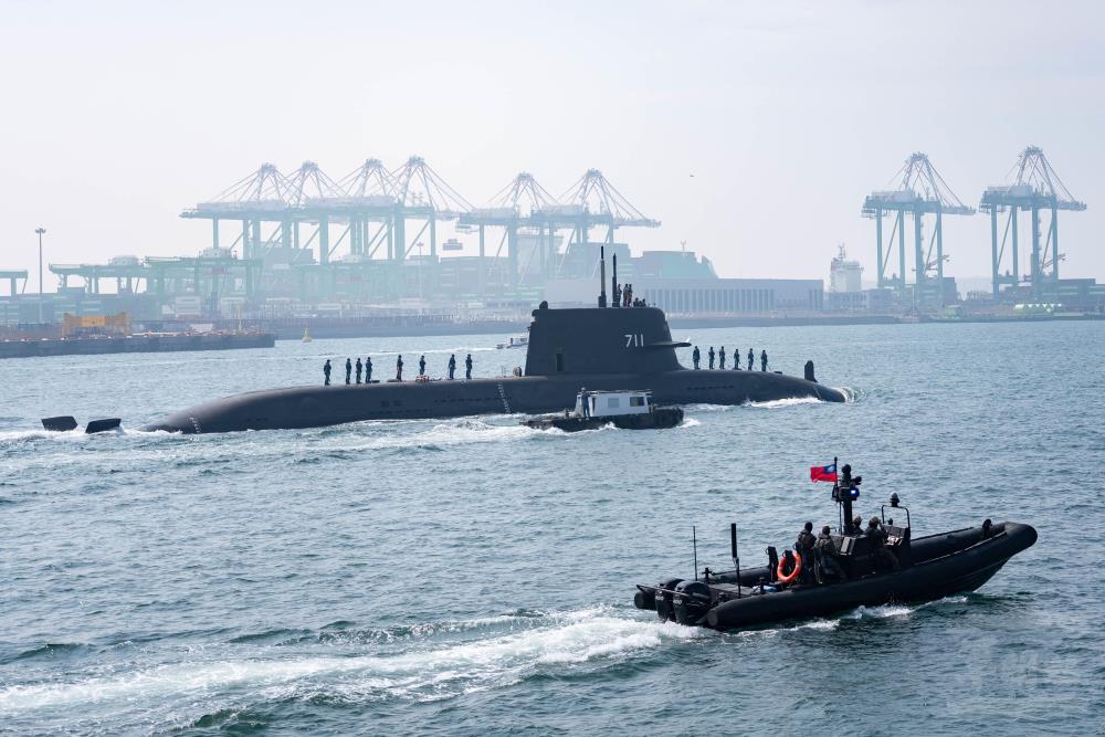 海鯤軍艦在M109快艇與海巡署船隻戒護下，駛離高雄港區。（軍聞社記者林庭暉攝）
